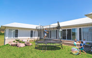 Boy playing basketball on an outdoor trampoline
