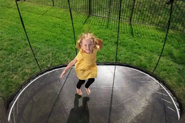 girl jumping on a huge trampoline