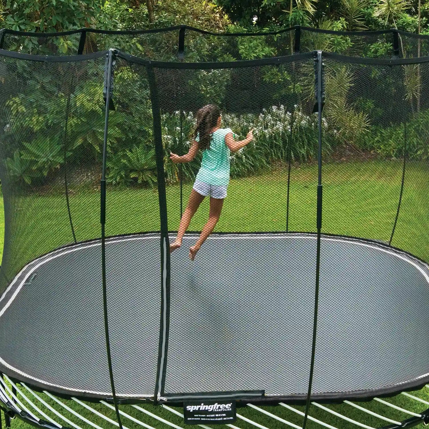 girl jumping on a large trampoline