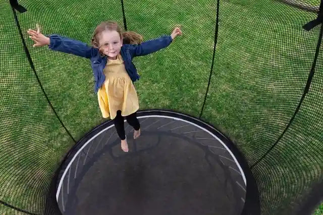 Girl jumping on a trampoline