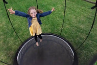 Load image into Gallery viewer, Girl jumping on a trampoline
